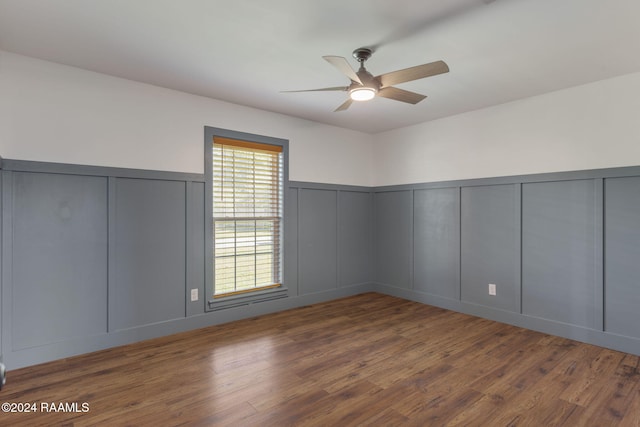 empty room featuring ceiling fan and dark hardwood / wood-style flooring