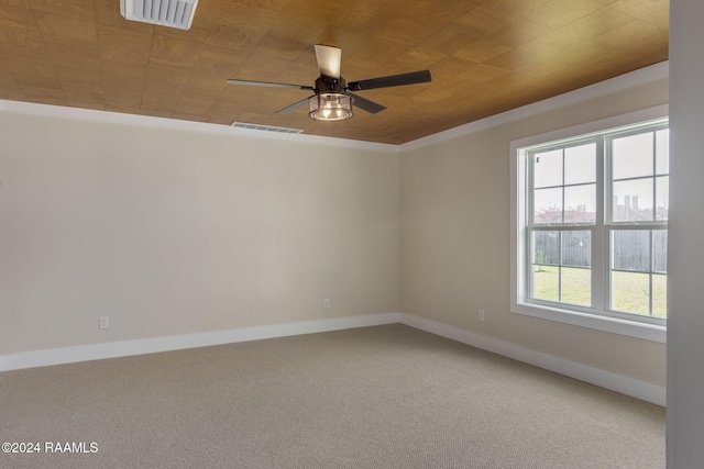 spare room with carpet floors, ceiling fan, and wooden ceiling