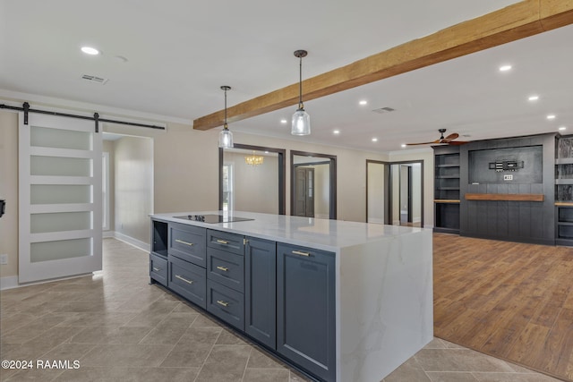 kitchen with pendant lighting, ceiling fan, a barn door, black electric cooktop, and light tile patterned floors