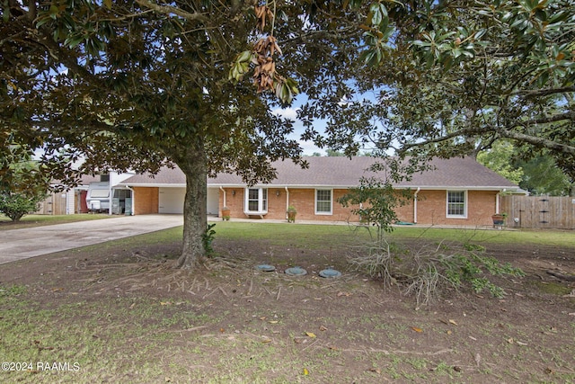 single story home with brick siding, fence, roof with shingles, a carport, and driveway