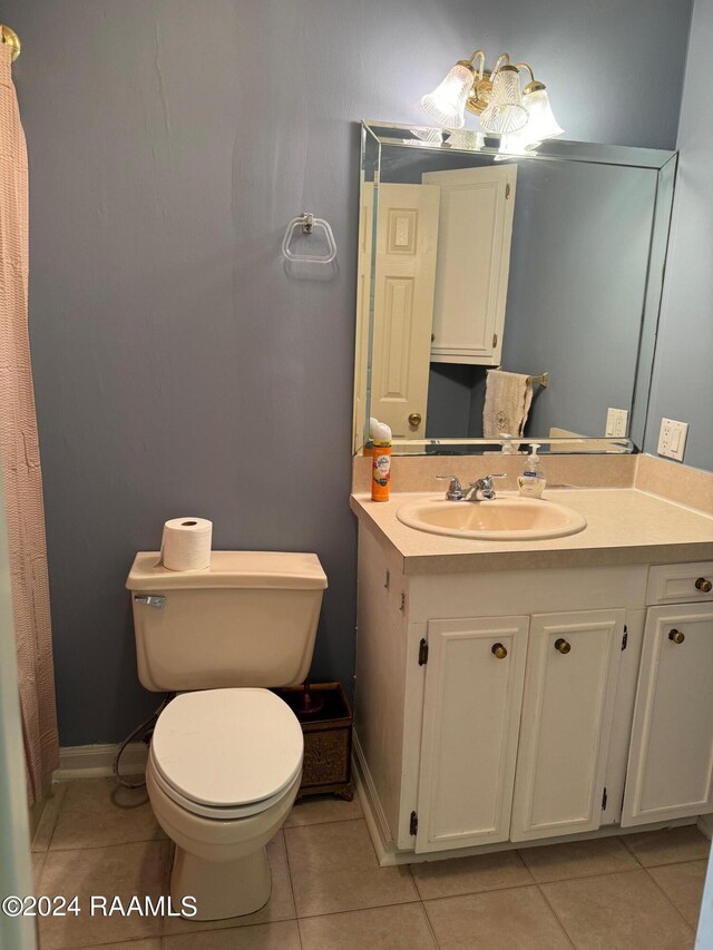 bathroom featuring tile patterned floors, vanity, and toilet