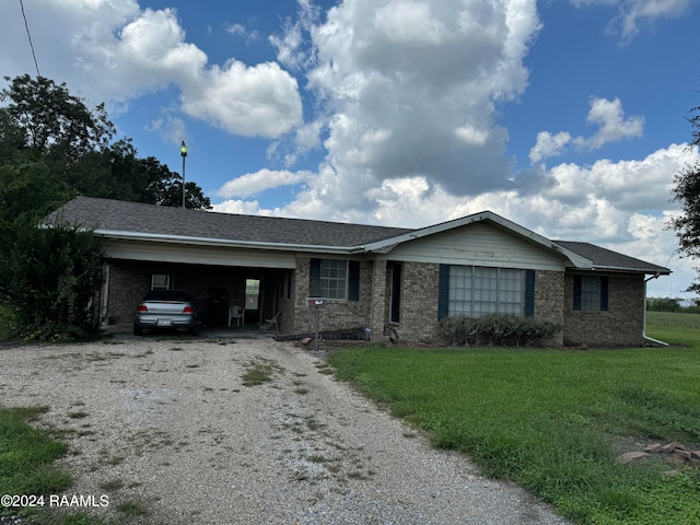 single story home featuring a carport and a front lawn