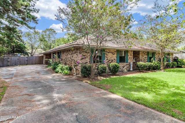 192 Tillou Andrus Dr, Opelousas, LA 70570 - ranch-style home featuring a gate, fence, driveway, a front lawn, and brick siding