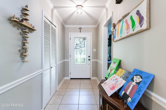 doorway to outside with a textured ceiling, crown molding, and light tile patterned flooring