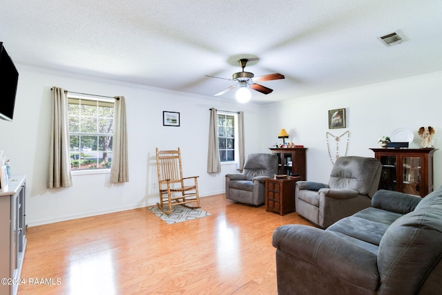 192 Tillou Andrus Dr, Opelousas, LA 70570 - living area featuring a ceiling fan, baseboards, visible vents, light wood-style flooring, and a textured ceiling
