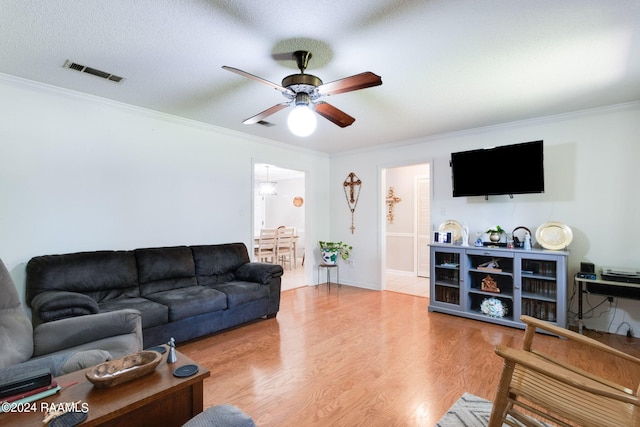 192 Tillou Andrus Dr, Opelousas, LA 70570 - living room with visible vents, crown molding, light wood-type flooring, and a ceiling fan