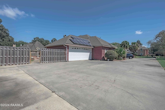 view of home's exterior featuring solar panels and a garage