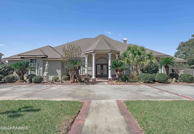 view of front facade featuring french doors and a front lawn