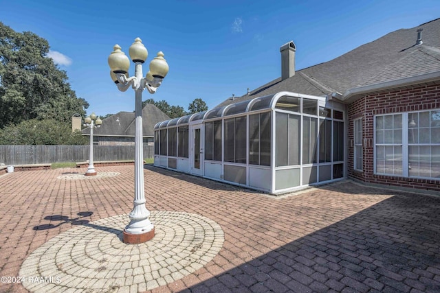 view of patio featuring a sunroom