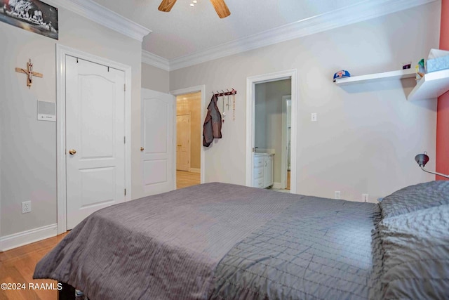 bedroom featuring ornamental molding, ensuite bath, ceiling fan, and light hardwood / wood-style flooring