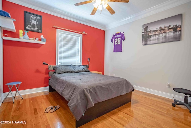 bedroom featuring ceiling fan, crown molding, and hardwood / wood-style floors