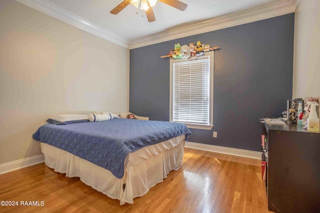 bedroom with ceiling fan, light hardwood / wood-style flooring, and ornamental molding