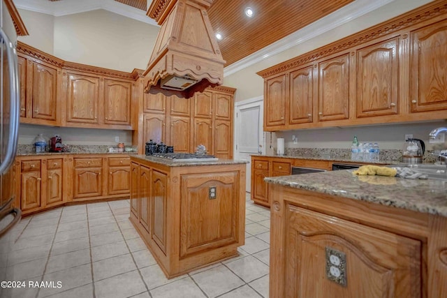 kitchen featuring ornamental molding, stainless steel gas cooktop, a center island, and light tile patterned floors