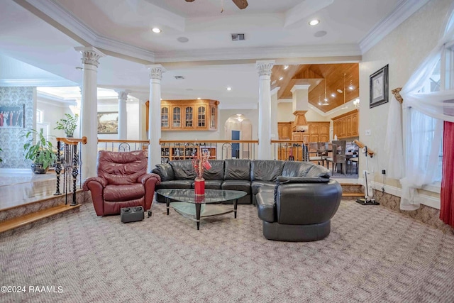 carpeted living room featuring ornamental molding, decorative columns, a tray ceiling, and ceiling fan