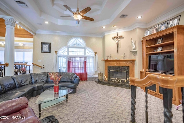 carpeted living room featuring a high end fireplace, ceiling fan, a raised ceiling, and crown molding