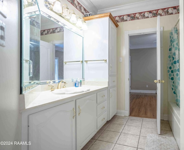 bathroom with tile patterned floors, vanity, crown molding, and shower / tub combo with curtain