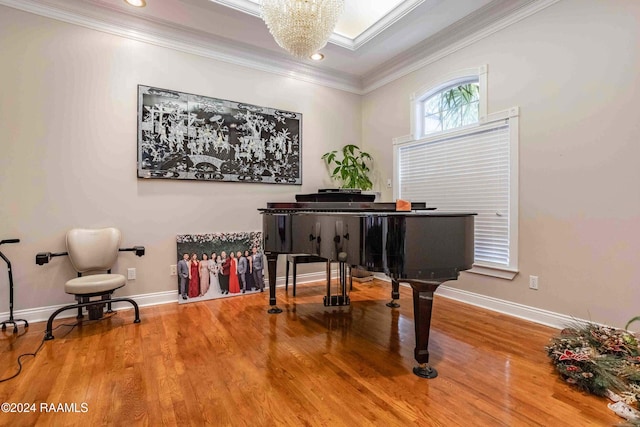 miscellaneous room featuring a notable chandelier, hardwood / wood-style flooring, and crown molding