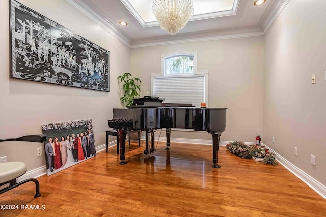 misc room featuring ornamental molding, an inviting chandelier, and hardwood / wood-style floors