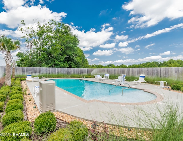 pool featuring a patio area and fence