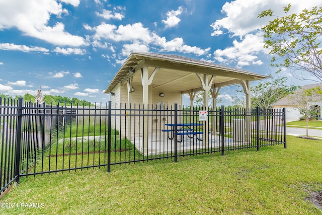 view of community with fence and a yard