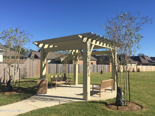 view of community featuring a pergola and a lawn