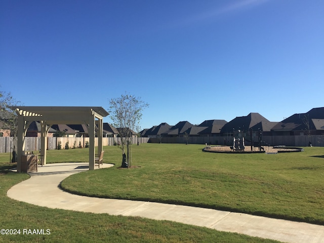 surrounding community with a yard, a residential view, fence, and a pergola