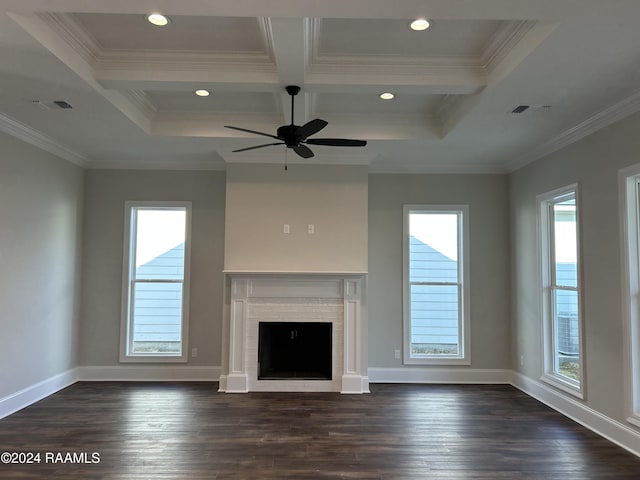 unfurnished living room with beamed ceiling, a brick fireplace, a wealth of natural light, and coffered ceiling