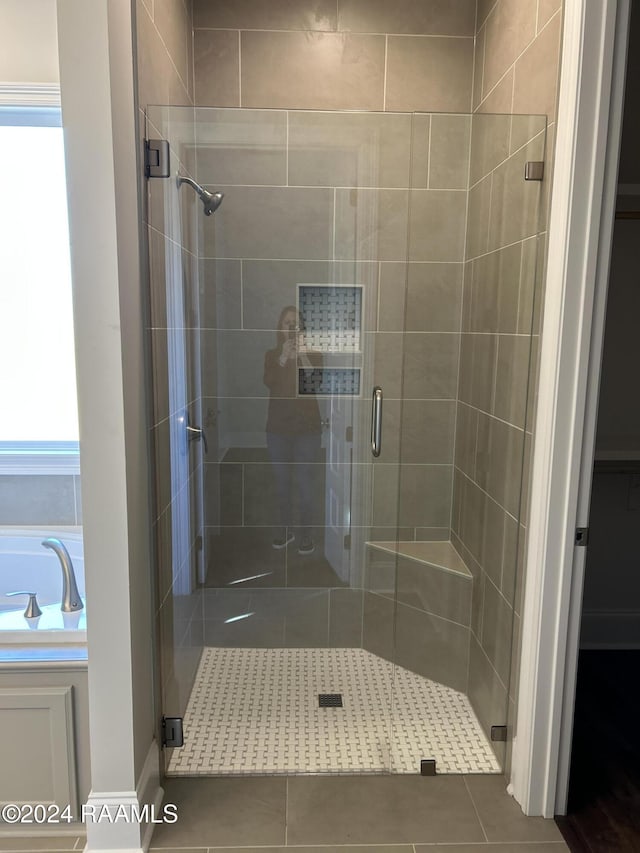 bathroom featuring tile patterned flooring and a shower with door