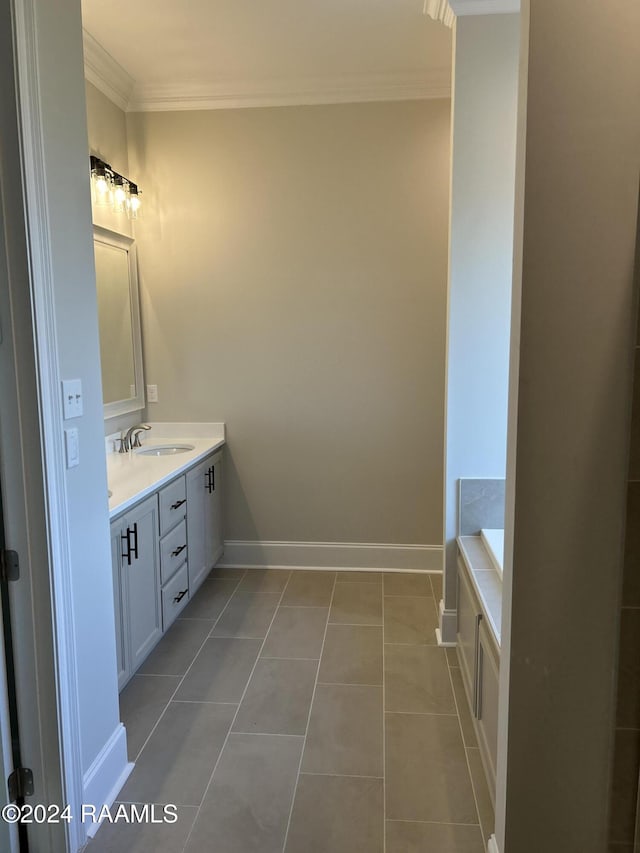 bathroom featuring tile patterned floors, vanity, a tub to relax in, and crown molding