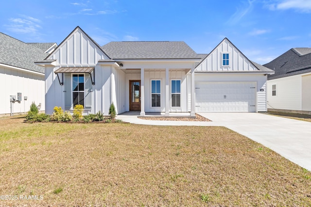 modern farmhouse featuring a shingled roof, concrete driveway, an attached garage, board and batten siding, and a front yard