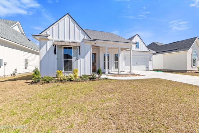 modern inspired farmhouse featuring board and batten siding, a front yard, concrete driveway, and an attached garage