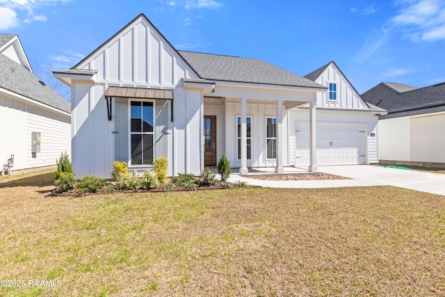 modern farmhouse with a garage, concrete driveway, roof with shingles, board and batten siding, and a front yard