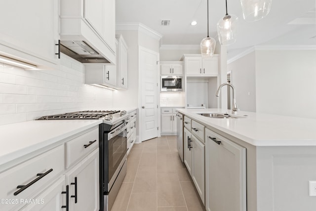 kitchen featuring light tile patterned floors, a sink, appliances with stainless steel finishes, decorative backsplash, and crown molding