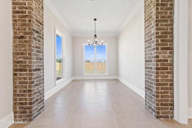 unfurnished dining area featuring a chandelier, ornamental molding, and baseboards