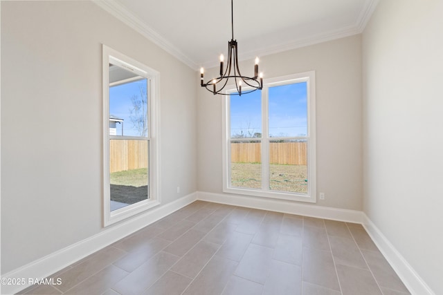 unfurnished room with ornamental molding, plenty of natural light, and baseboards