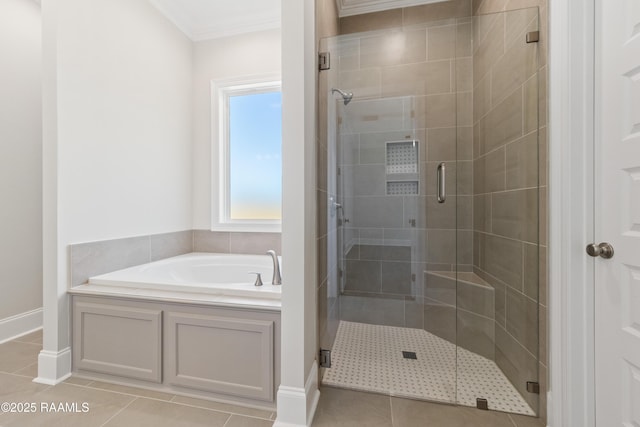 full bath featuring baseboards, ornamental molding, tile patterned floors, a garden tub, and a shower stall