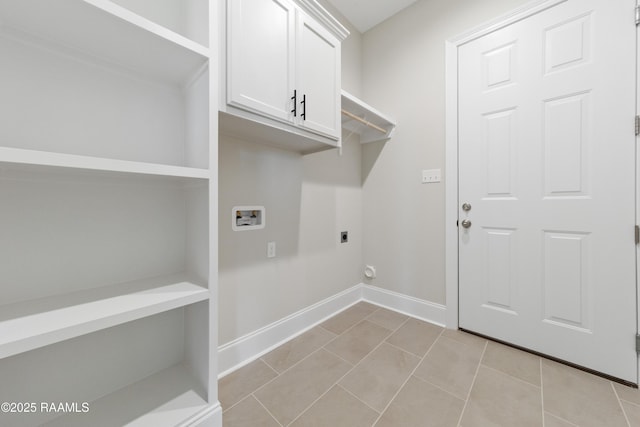 laundry area featuring hookup for a washing machine, cabinet space, hookup for an electric dryer, light tile patterned flooring, and baseboards