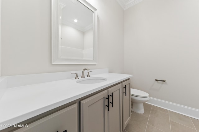 bathroom featuring toilet, ornamental molding, vanity, tile patterned flooring, and baseboards