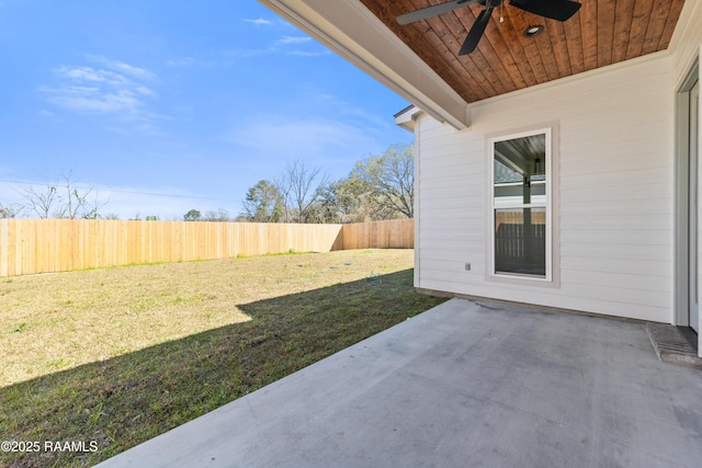 view of yard featuring a patio area, ceiling fan, and a fenced backyard