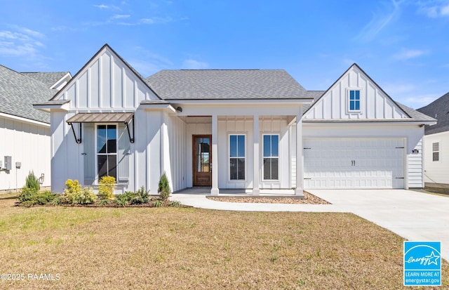 modern farmhouse style home featuring driveway, a garage, a shingled roof, a front lawn, and board and batten siding