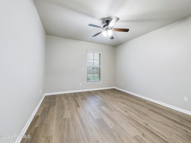 empty room with ceiling fan and light hardwood / wood-style floors