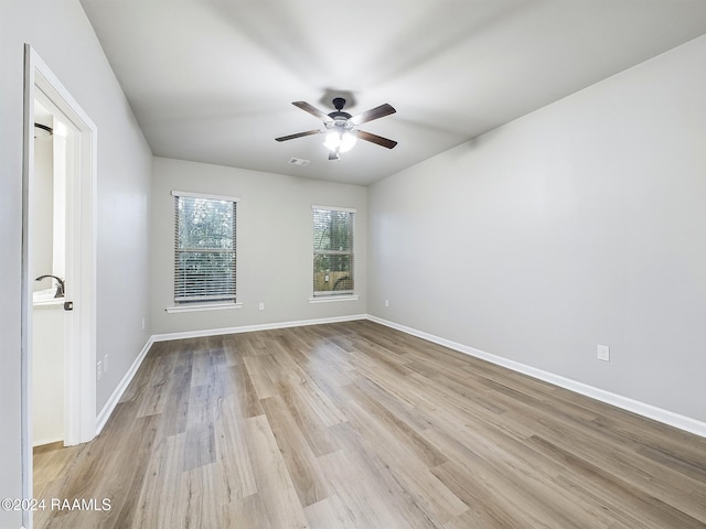 unfurnished room featuring ceiling fan and light wood-type flooring