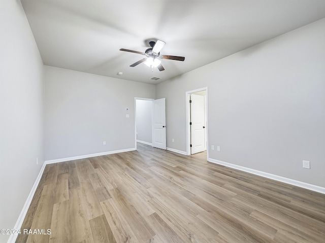 spare room featuring light hardwood / wood-style flooring and ceiling fan