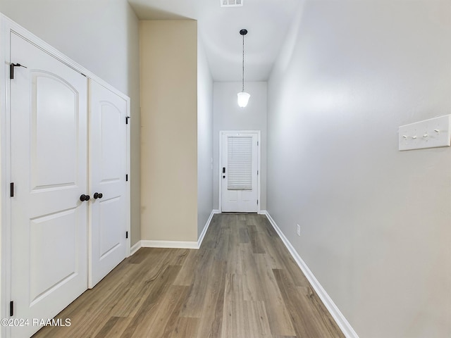 hall with hardwood / wood-style floors