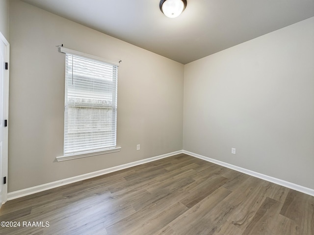 unfurnished room featuring hardwood / wood-style floors and plenty of natural light