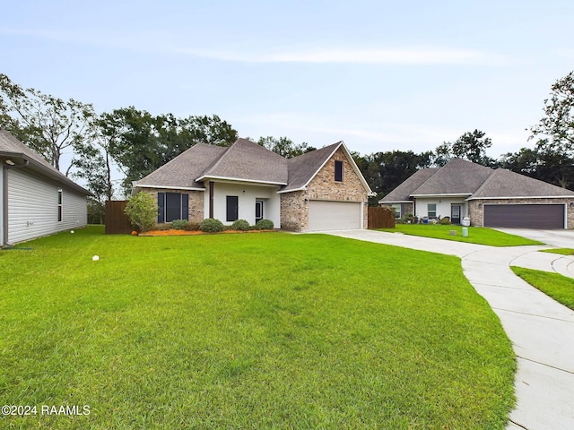 view of front of home with a front lawn and a garage