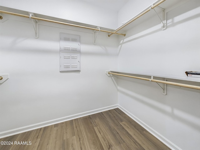 walk in closet with hardwood / wood-style floors