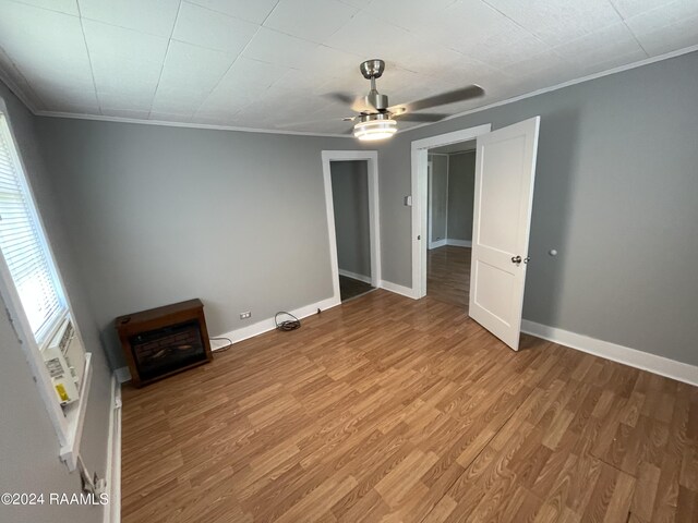 unfurnished room featuring crown molding, hardwood / wood-style flooring, and ceiling fan