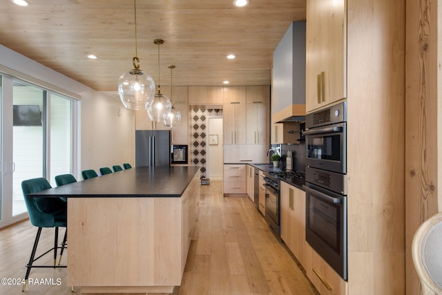 kitchen featuring built in refrigerator, a kitchen bar, decorative light fixtures, light brown cabinetry, and light hardwood / wood-style floors