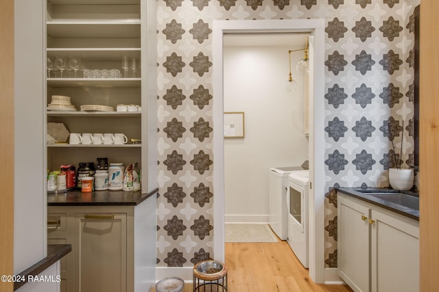 pantry with washing machine and clothes dryer and sink